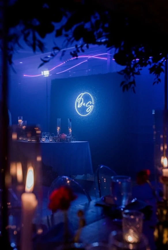 Custom wedding neon name sign used as a reception backdrop