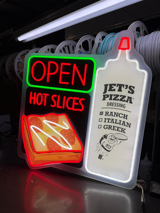 Custom neon signs reading OPEN and HOT SLICE with a menu light in a pizza shop