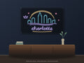 Charlotte Skyline Neon Sign shown above a walnut console in a styled room mockup