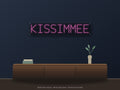 Kissimmee City Name Neon Sign shown above a walnut console in a styled room mockup