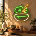 Design Preview: Matcha Daydream Neon Sign in an intimate home tea station with limewashed warm stone walls, a floating walnut shelf, a textured ceramic bowl and a small bonsai; early morning light. Generated room visualization, predefined colors shown.