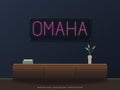 Omaha City Name Neon Sign shown above a walnut console in a styled room mockup