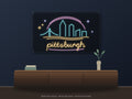 Pittsburgh Skyline Neon Sign shown above a walnut console in a styled room mockup