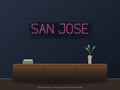 San Jose City Name Neon Sign shown above a walnut console in a styled room mockup