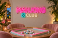 Mahjong Club neon sign with a five-pip teal tile in a social-club lounge - design preview
